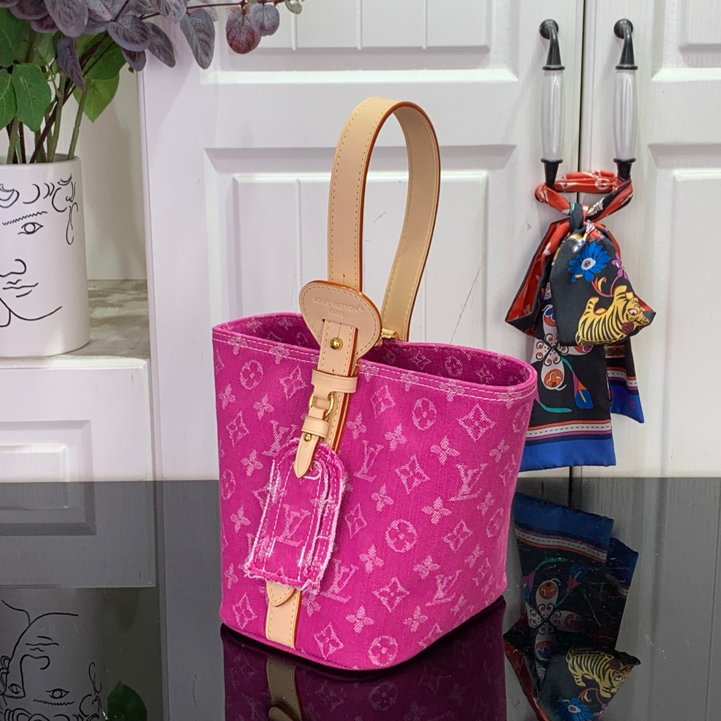 Magenta monogram bucket tote with tan leather handles and front key fob