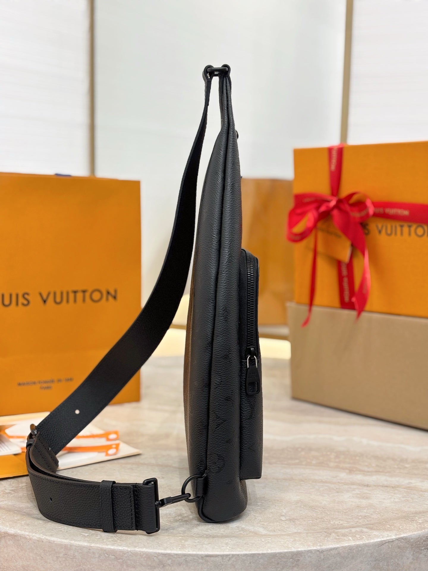 Louis Vuitton black monogram sling bag side view with adjustable strap
