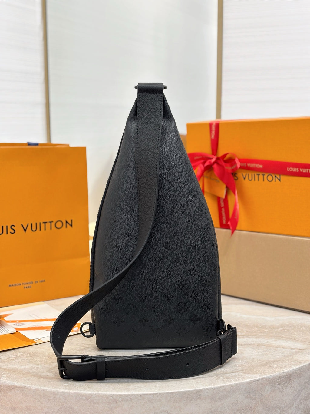Louis Vuitton black monogram sling bag front view with crossbody strap