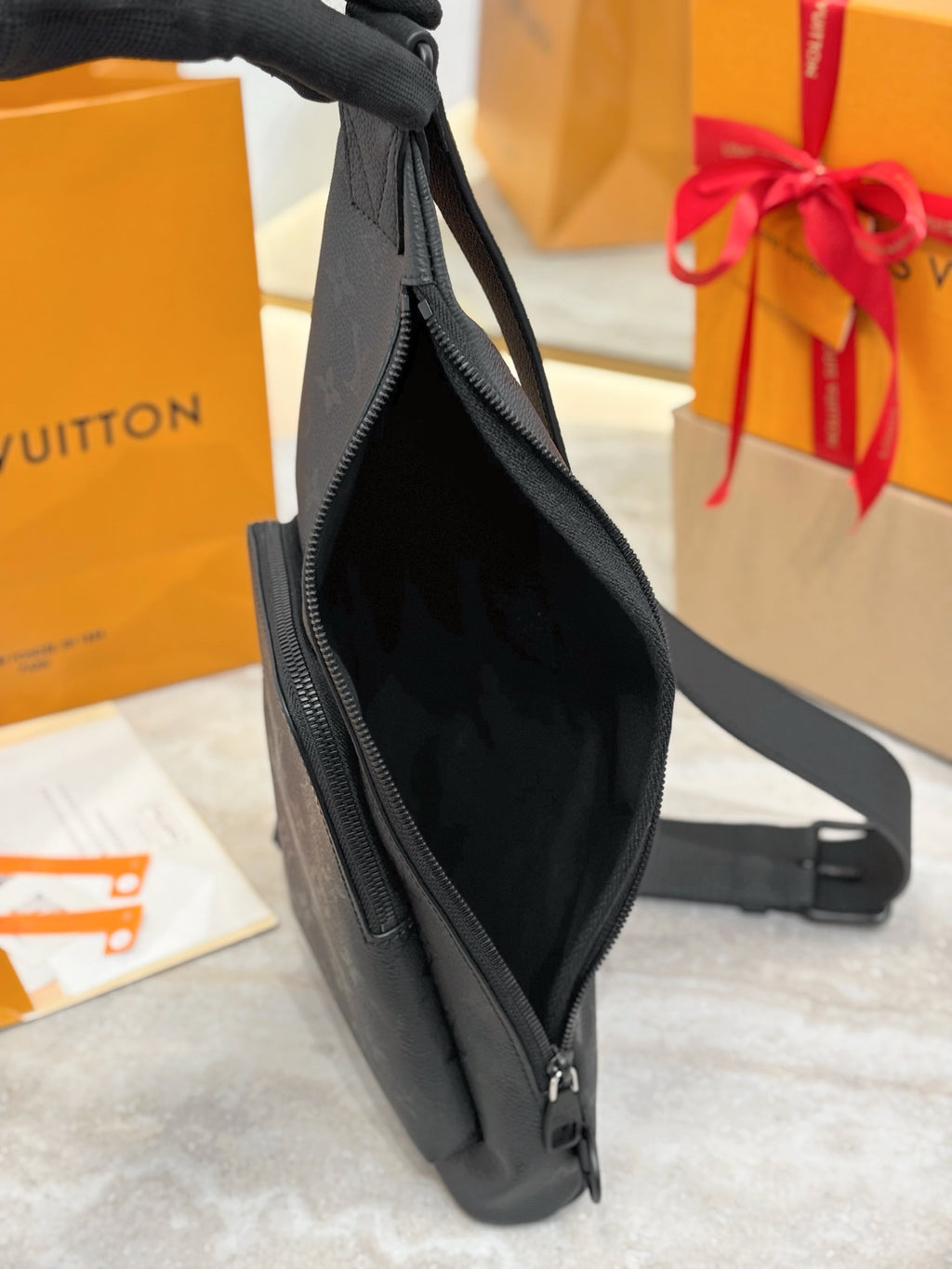 Louis Vuitton black monogram sling bag open view with zipper and strap