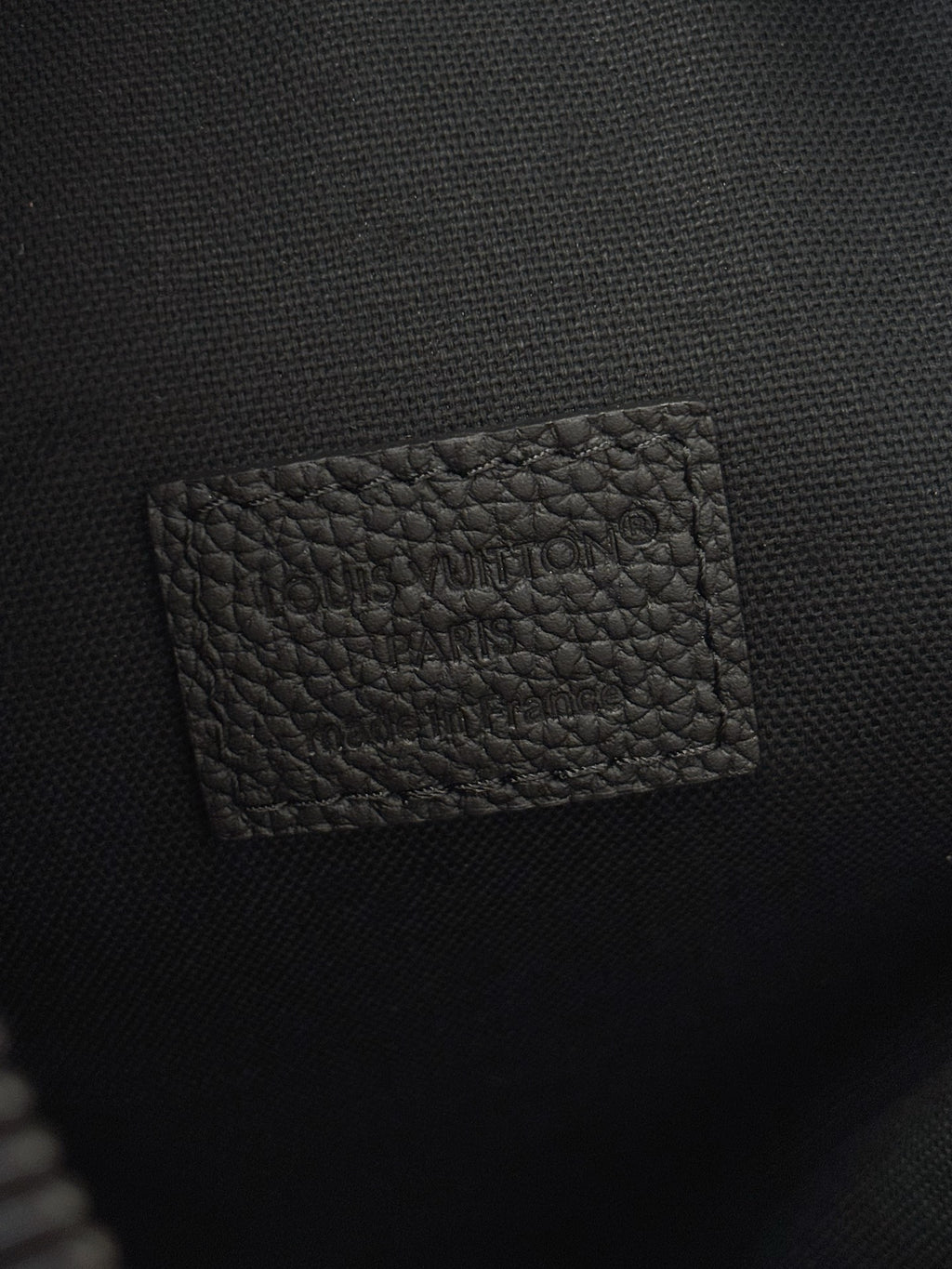 Louis Vuitton black leather interior pocket panel with embossed logo