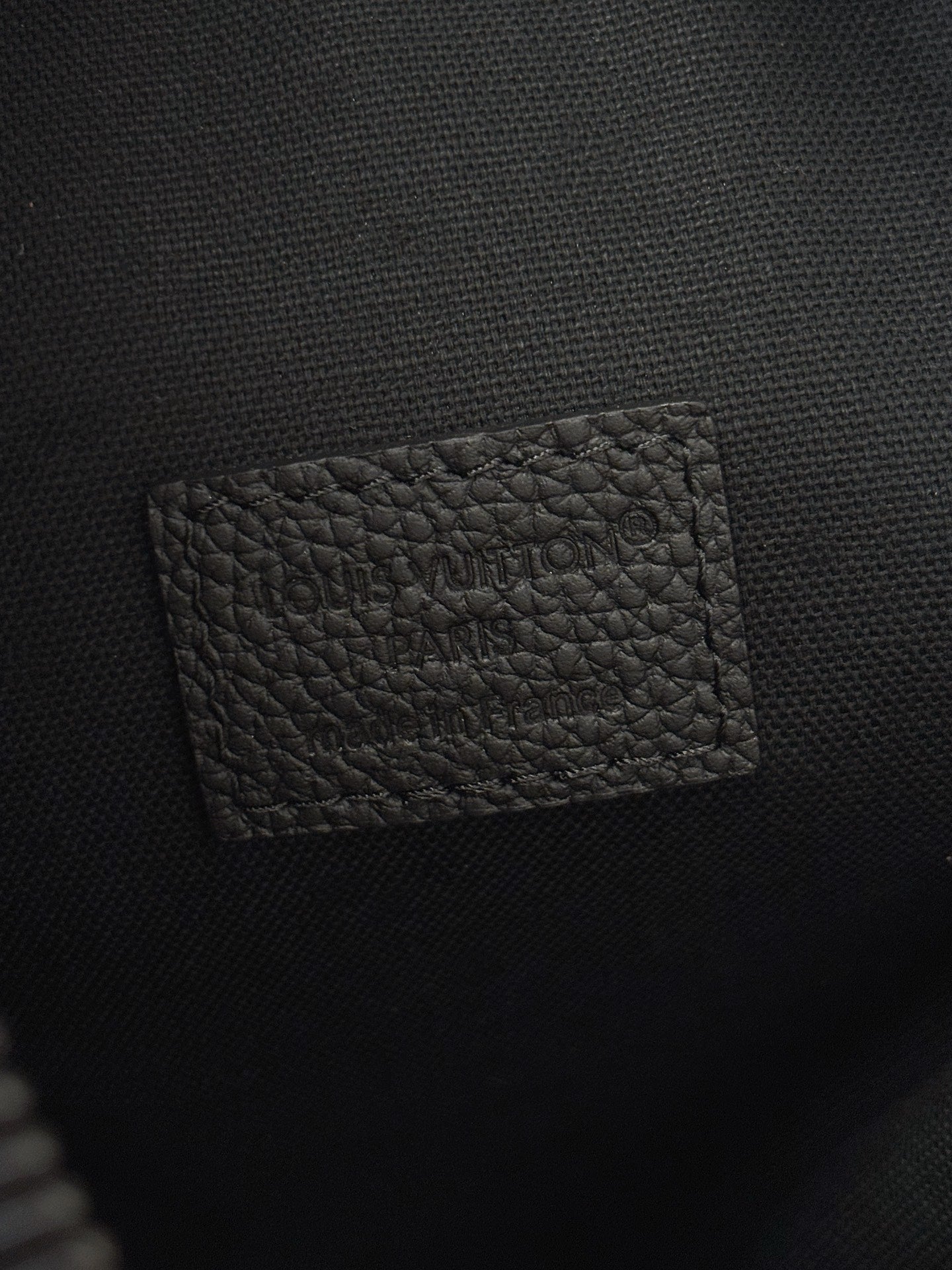 Louis Vuitton black leather interior pocket panel with embossed logo