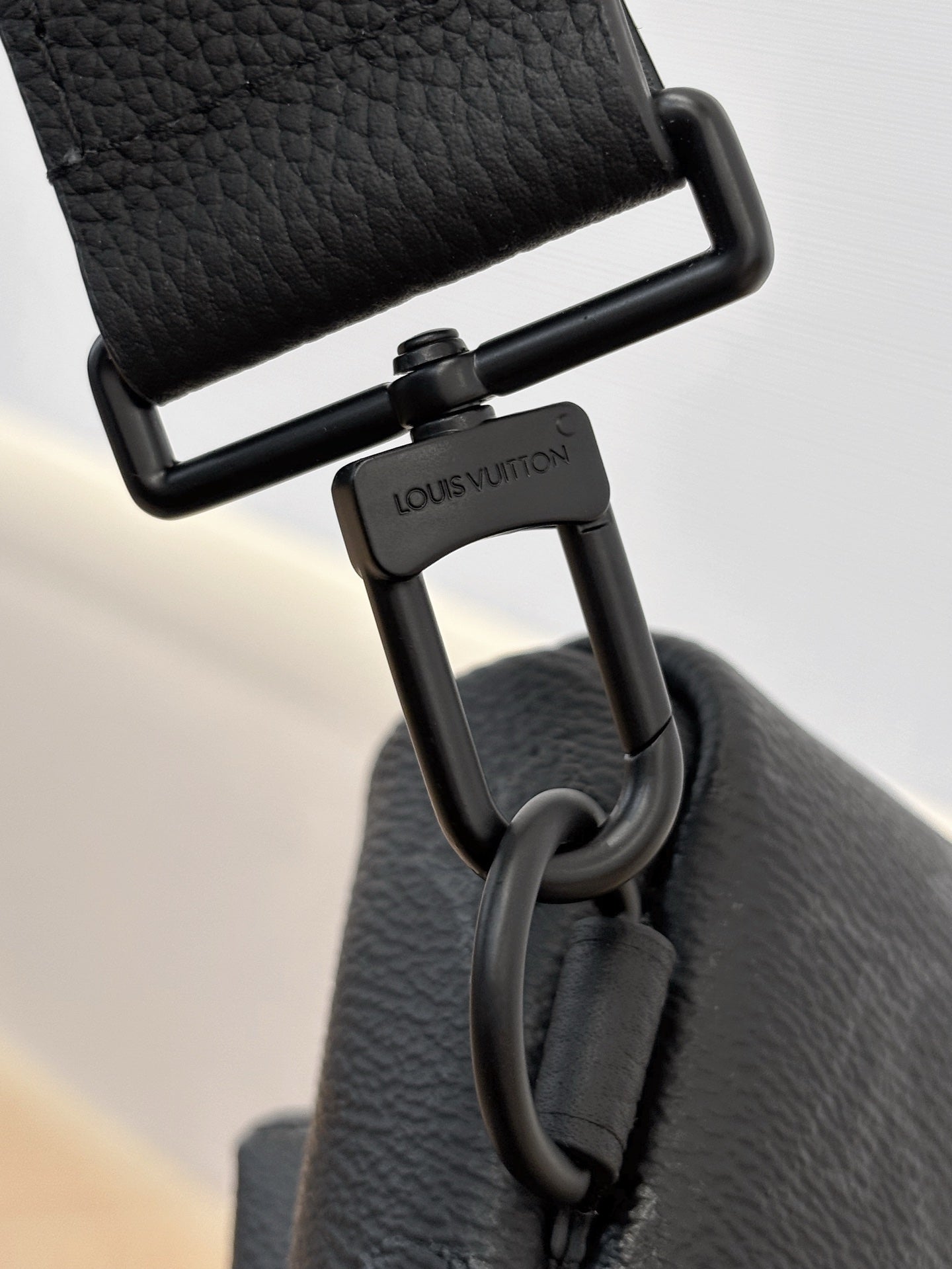 Louis Vuitton black strap hardware with engraved logo and D-ring