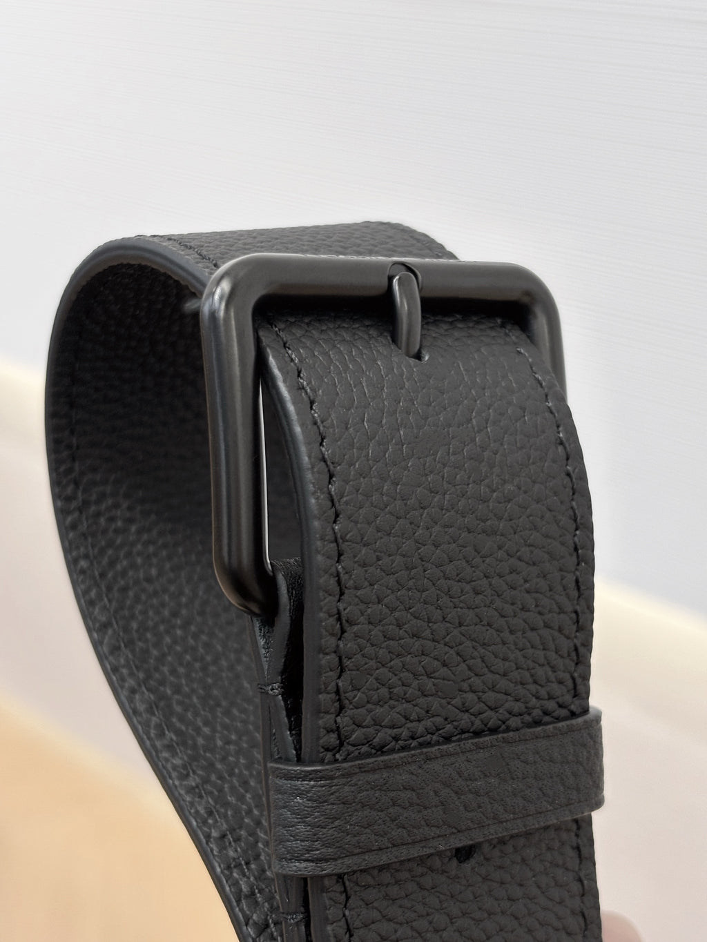 Louis Vuitton black leather strap connector with textured grain finish