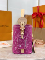 Purple monogram bucket bag with tan leather strap and front clasp hardware