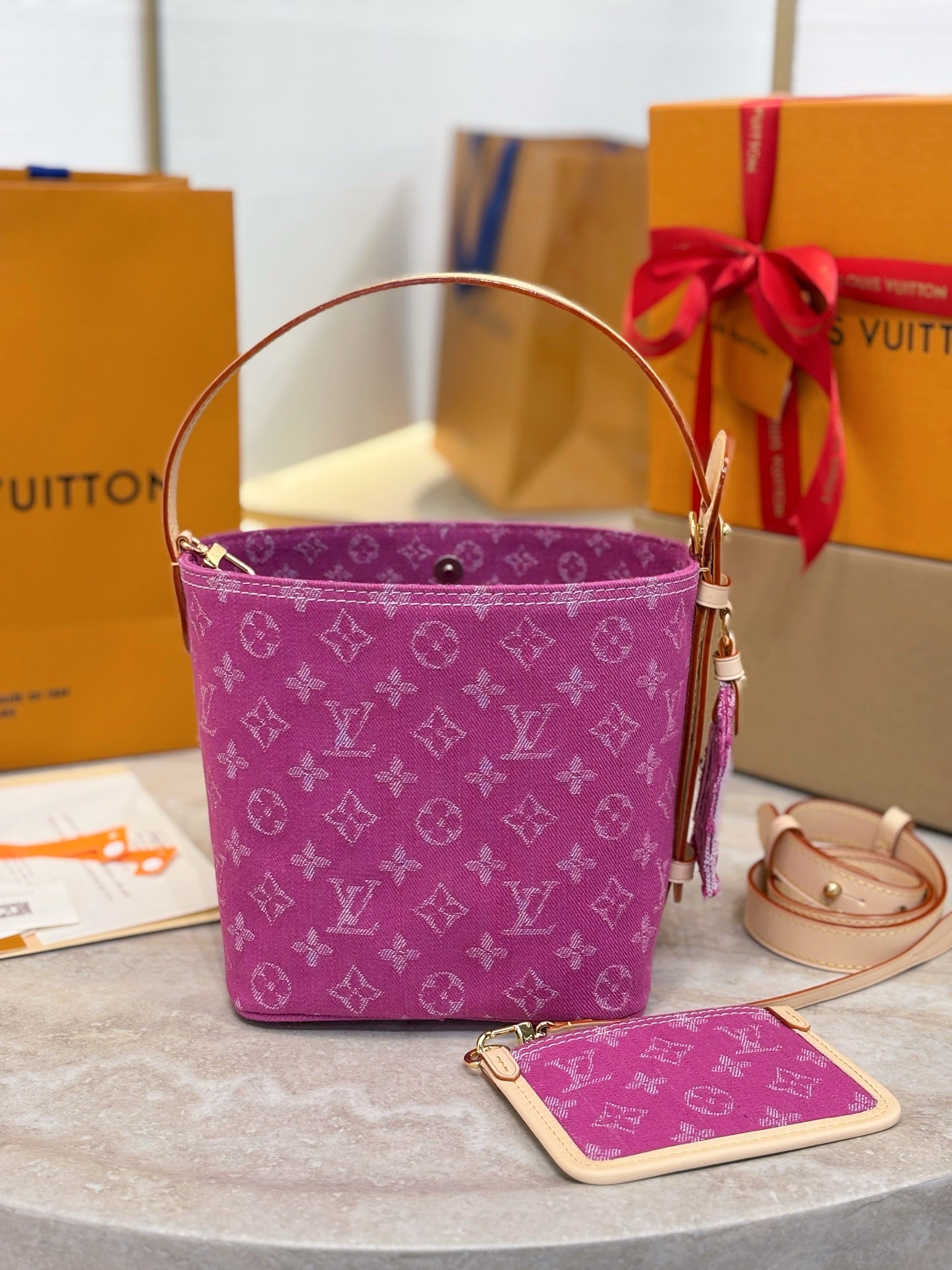 Purple monogram bucket bag with long strap and small card pouch