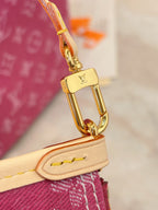 Gold clasp hardware on tan strap with purple monogram bag