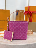 Purple monogram bucket bag with matching small pouch on display