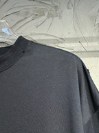 Black crewneck T-shirt, plain chest with visible shoulder seam and drape