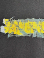 Black crewneck T-shirt with close-up yellow, blue, and aqua paint-style graphic print