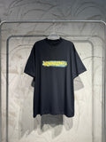 Balenciaga black crewneck T-shirt with yellow and blue graphic print on chest