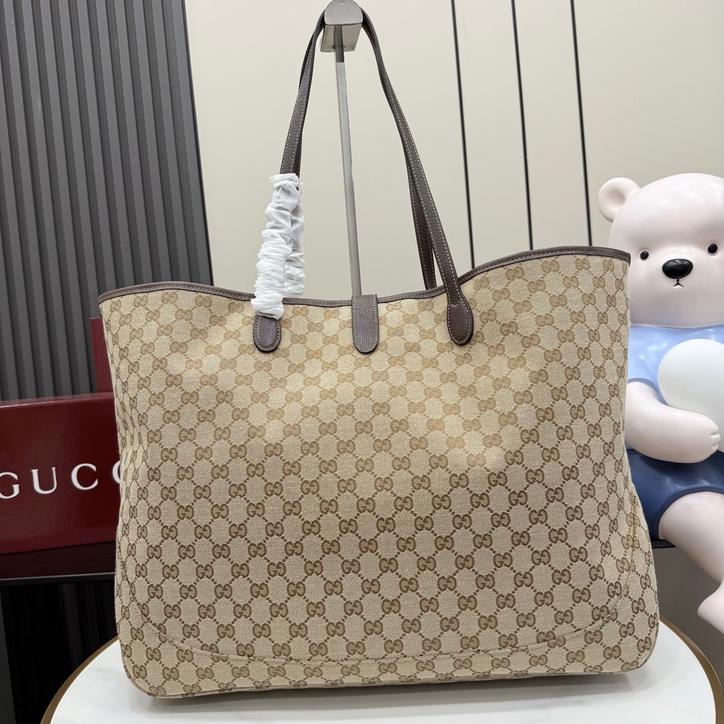 Gucci GG canvas tote bag with dark top handles and gold hardware, front view