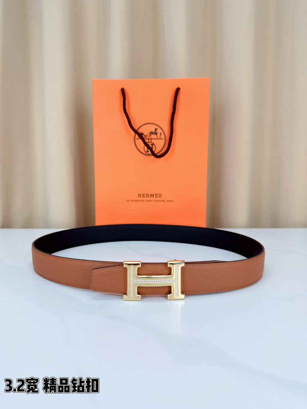 Leather belt with tan strap and dark lining, silver H buckle