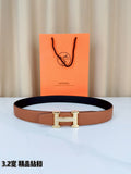 Leather belt with tan strap and dark lining, silver H buckle