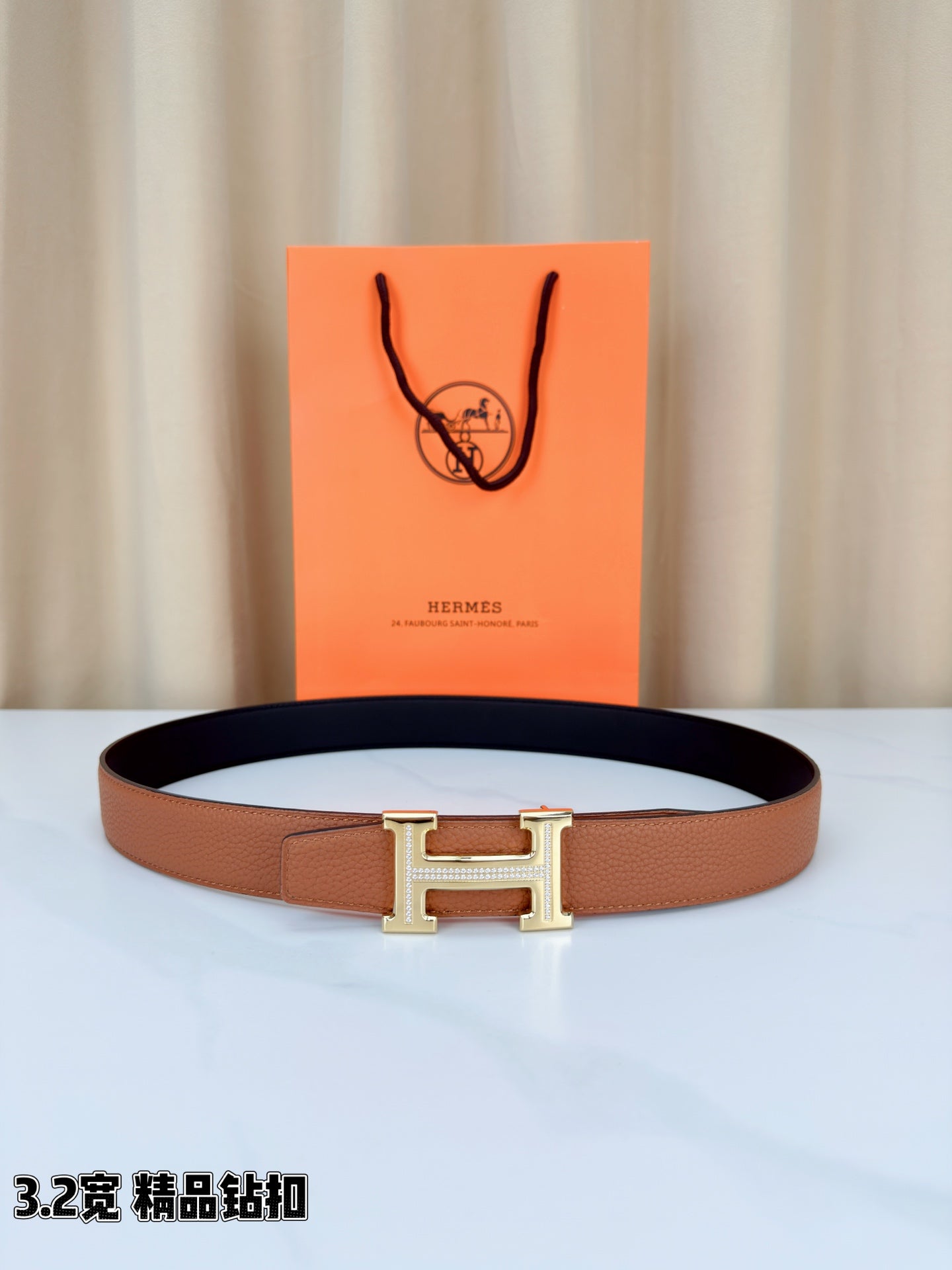 Leather belt with tan strap and dark lining, silver H buckle