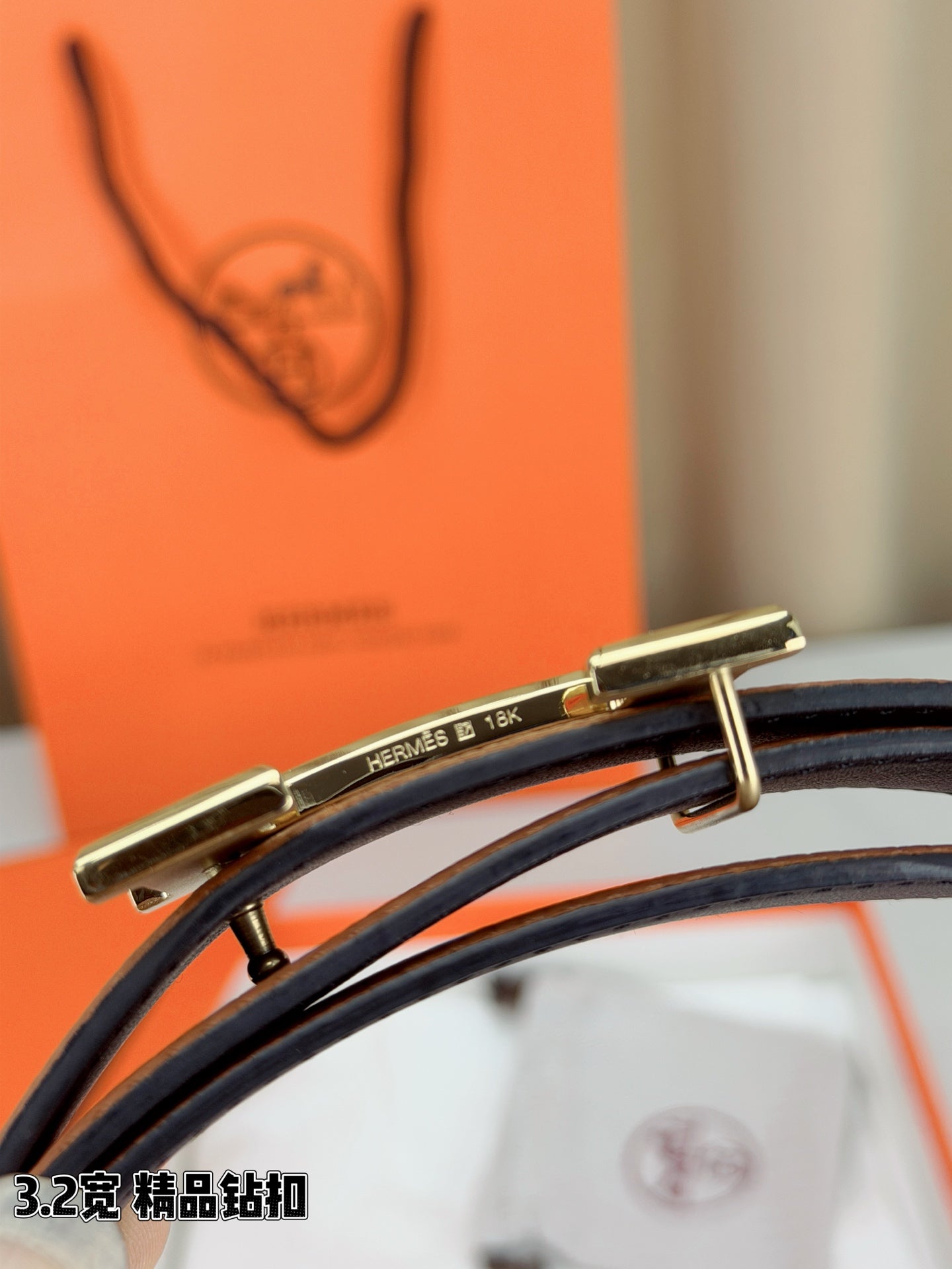 Leather belt close-up: silver buckle hardware over tan strap on dark leather
