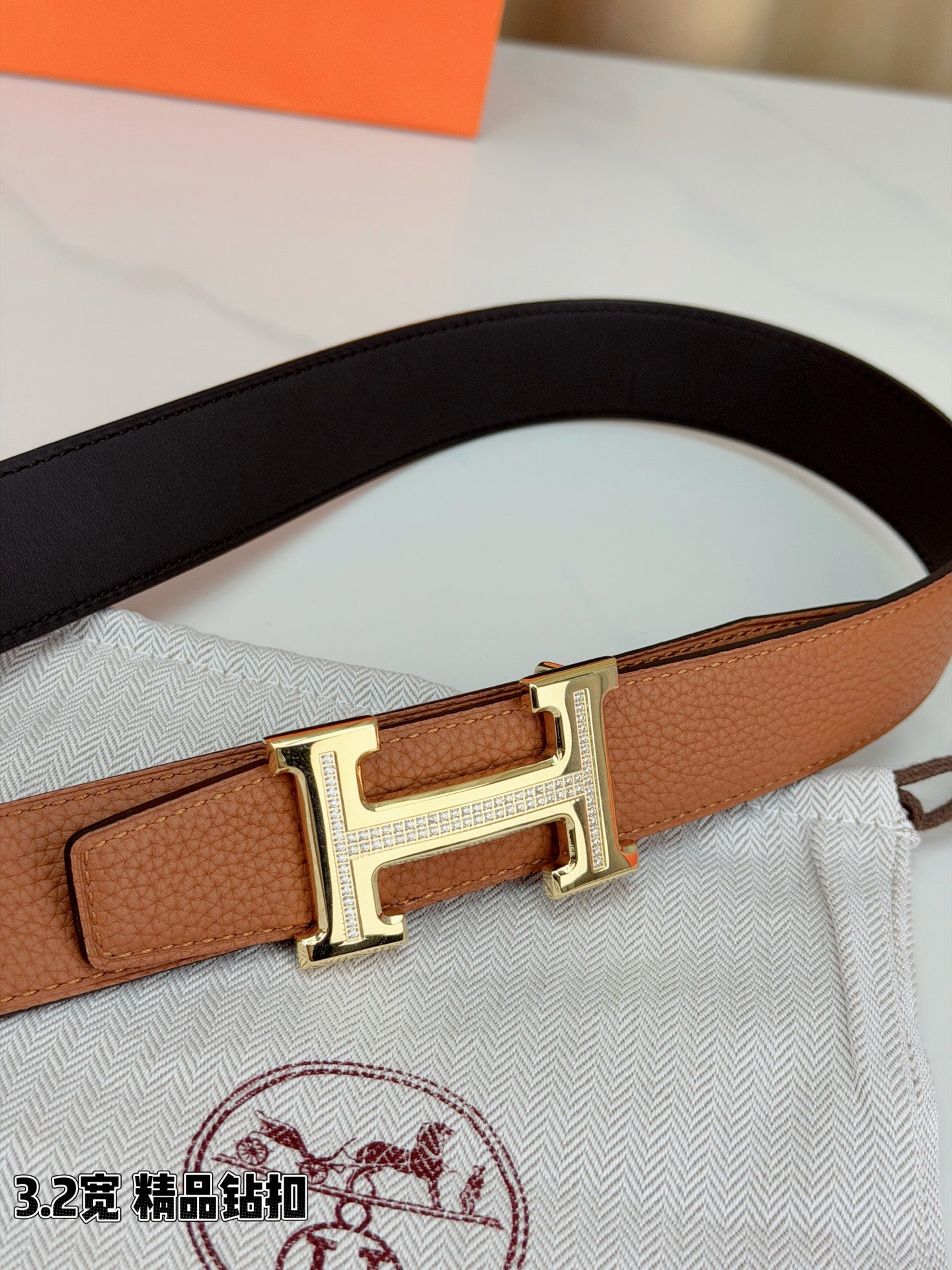 Brown leather belt with silver H buckle and adjustable strap holes