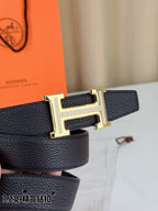 Hermes belt close-up: gold-tone H buckle on dark pebbled leather