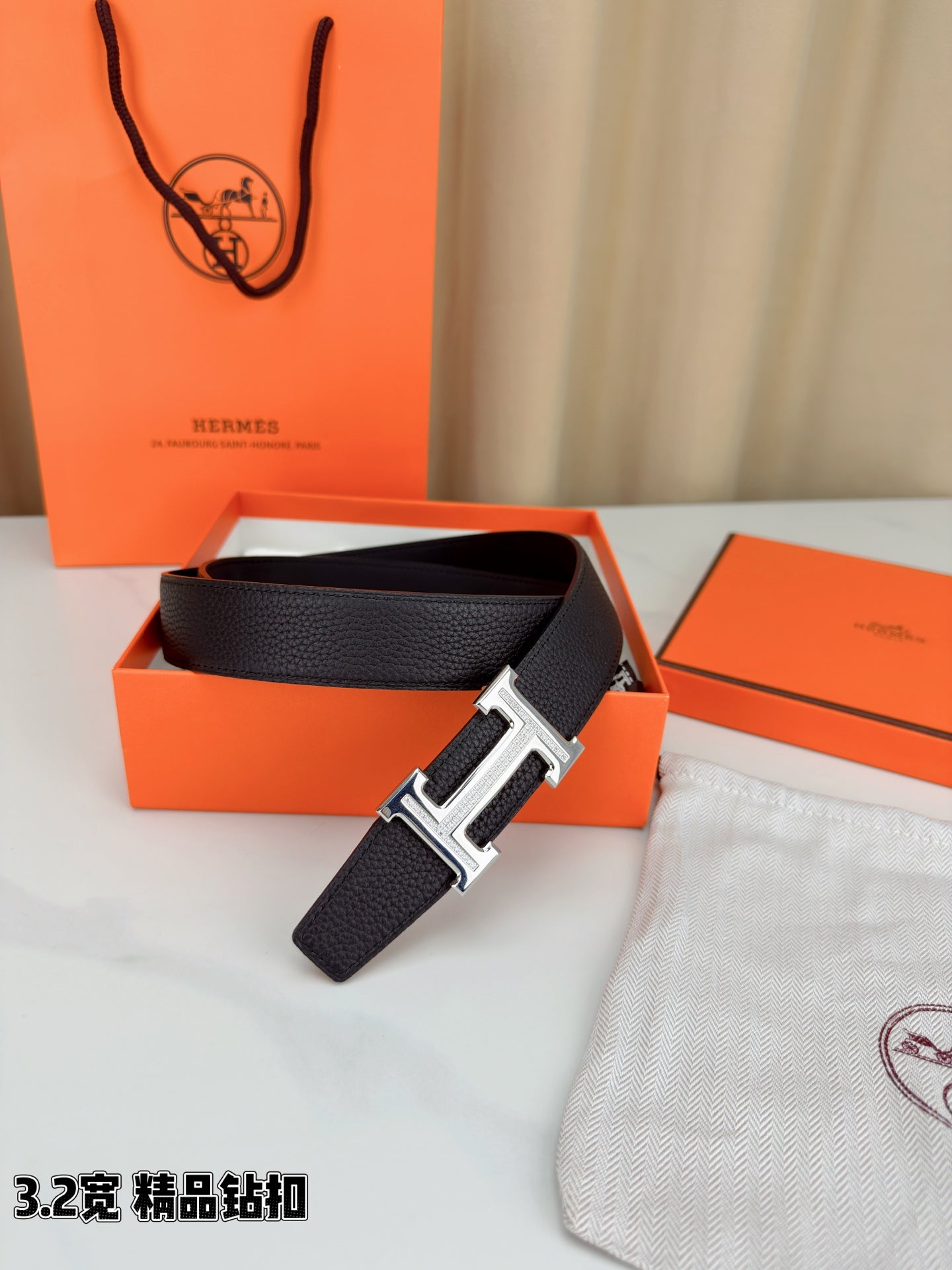 Hermes belt with dark leather strap and silver-tone H buckle