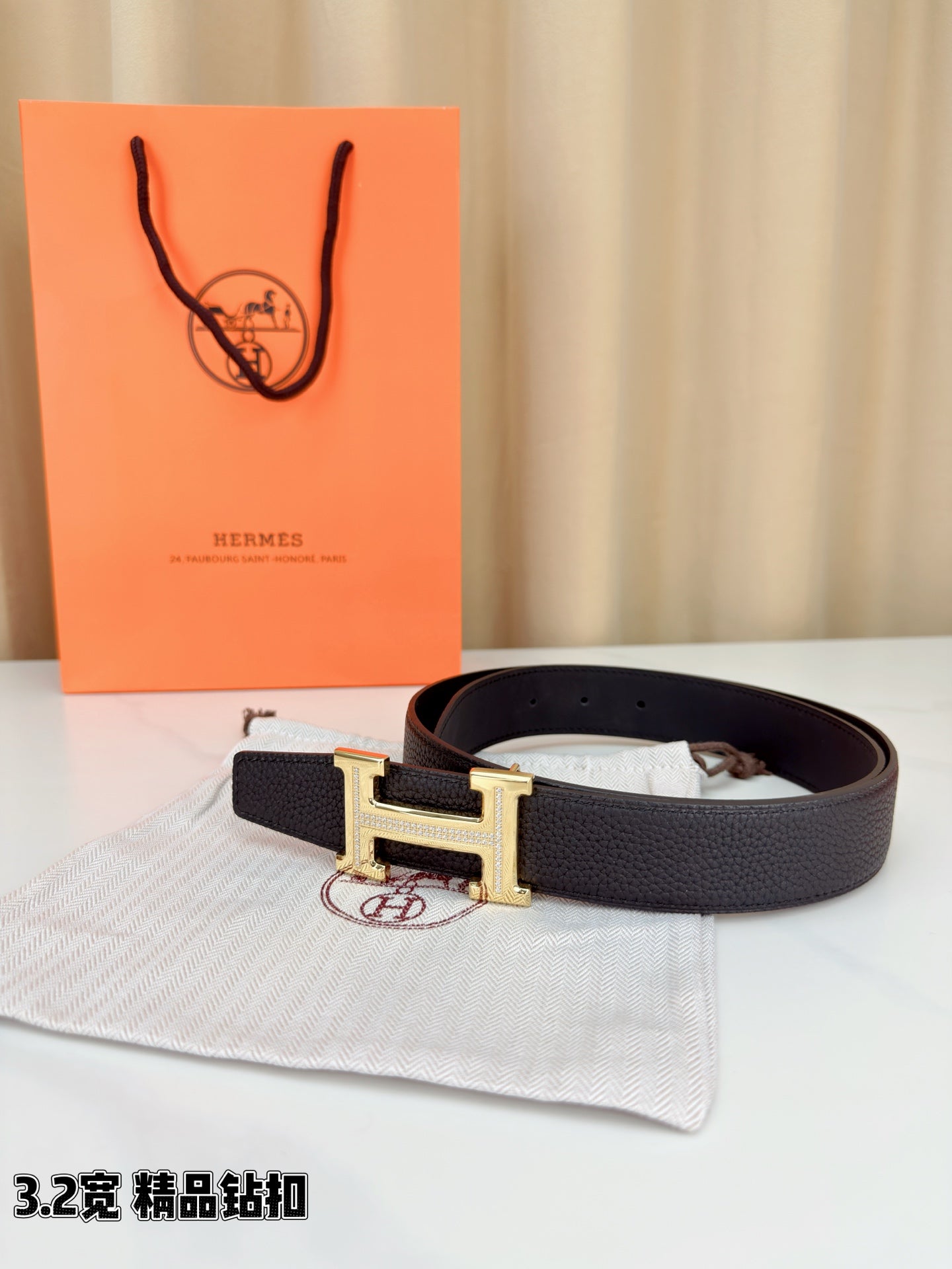 Hermes belt with dark leather strap and gold-tone H buckle