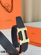 Hermes belt end close-up: dark strap with gold-tone H buckle