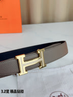 Light gray Hermes belt with gold-tone H buckle and textured belt keep