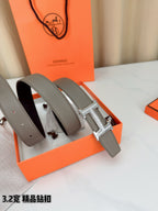 Light gray Hermes belt with silver-tone H buckle, two strap loops shown