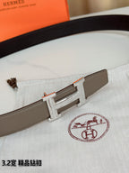 Light gray Hermes belt with silver-tone H buckle on patterned cloth
