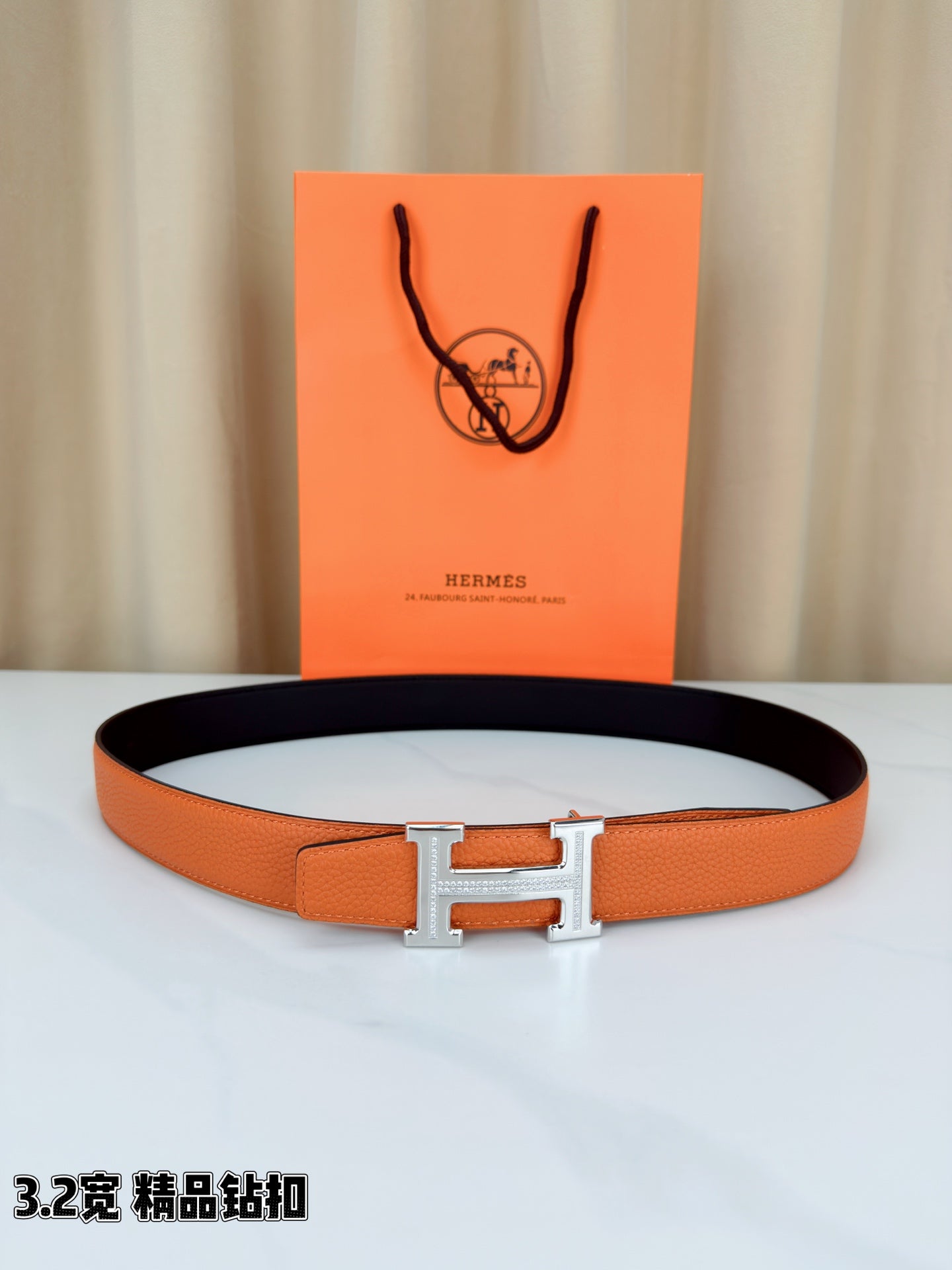 Hermes H-buckle belt, orange leather with silver buckle and black underside