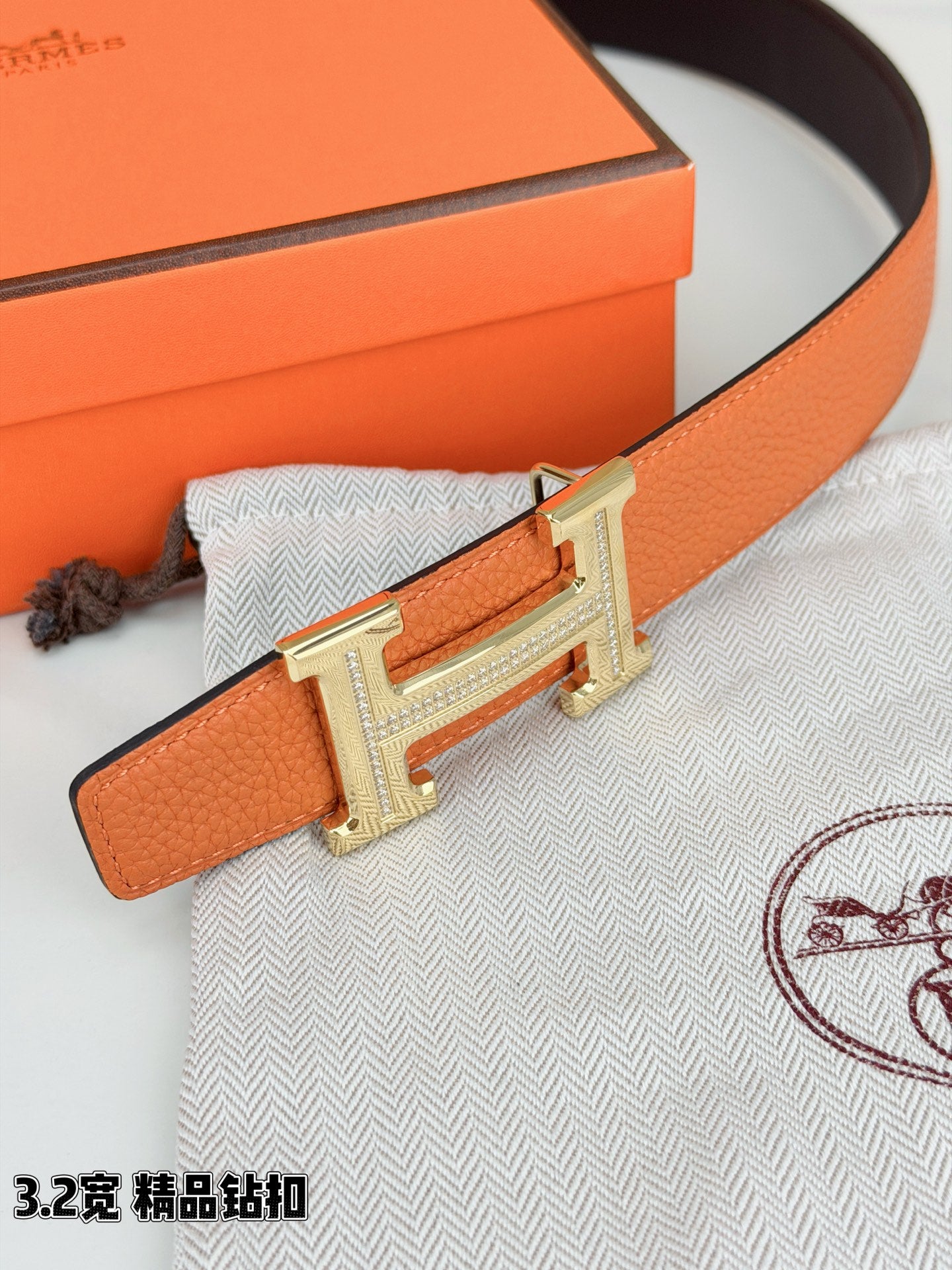 Hermes H-buckle belt, orange pebbled leather with silver H buckle detail