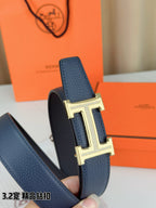 Hermes belt buckle detail with textured blue strap and silver H hardware