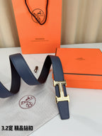 Hermes belt draped on dust cloth, dark blue strap with silver H buckle