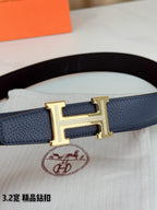 Hermes belt buckle close-up: silver H clasp on blue textured leather