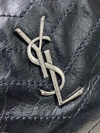 YSL metal logo on dark black quilted leather bag front