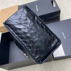 Quilted black leather clutch or tote with chain strap and top-edge trim