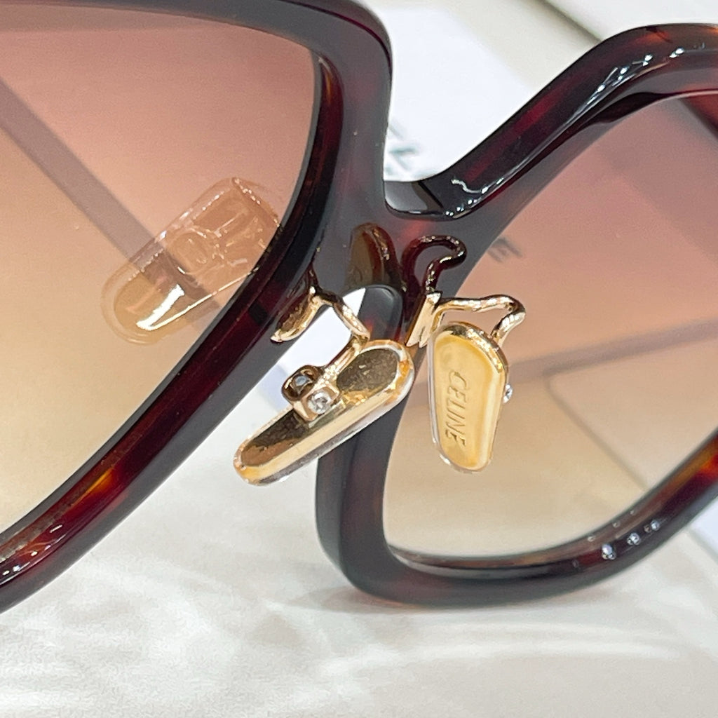 Celine acetate eyeglasses hinge close-up with tortoiseshell frame and gold detail