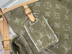 Olive monogram bag close-up with stitched leather strap and woven edging