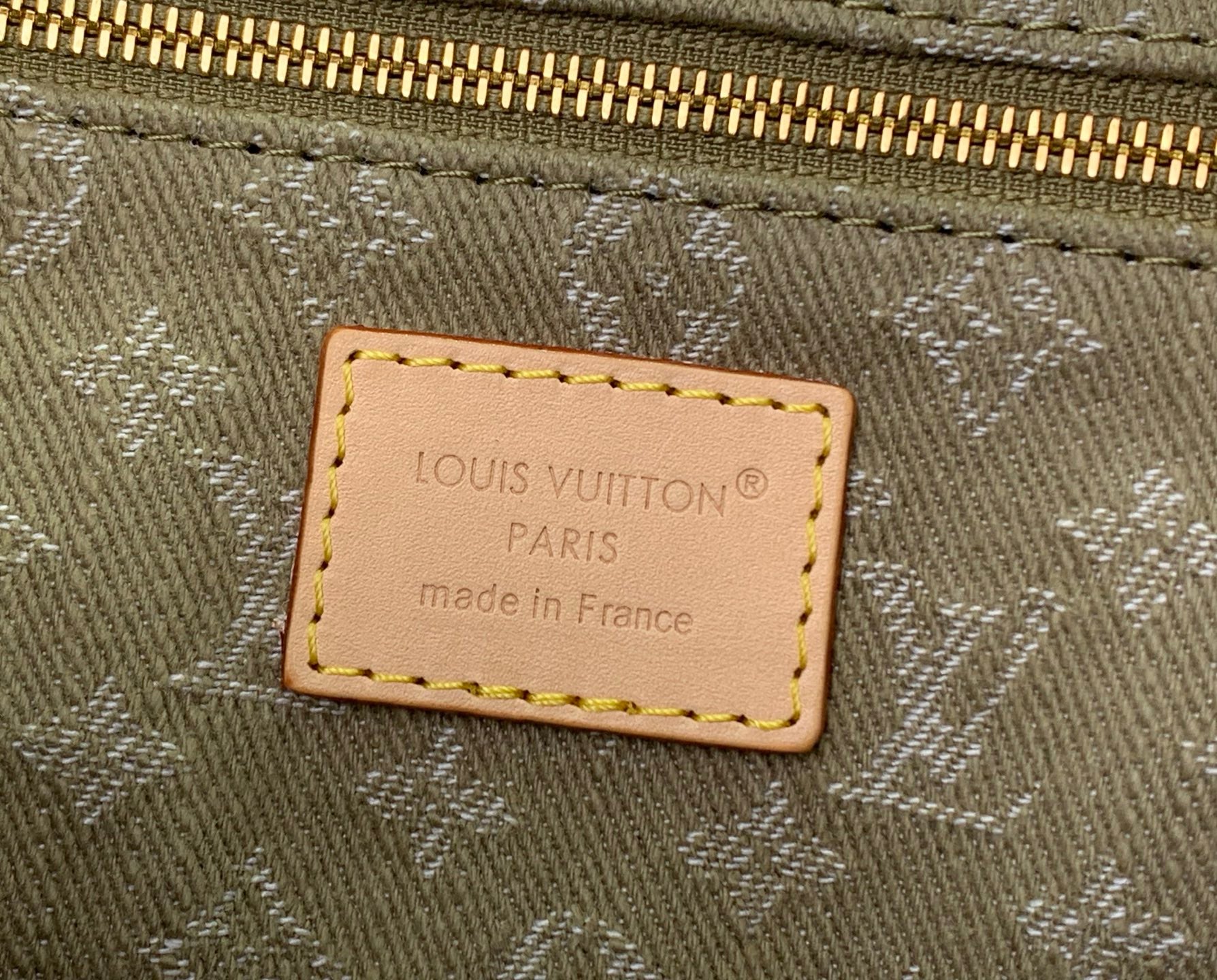 Olive canvas Louis Vuitton bag with leather logo patch