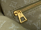 Gold LV monogram zipper pull on olive canvas bag