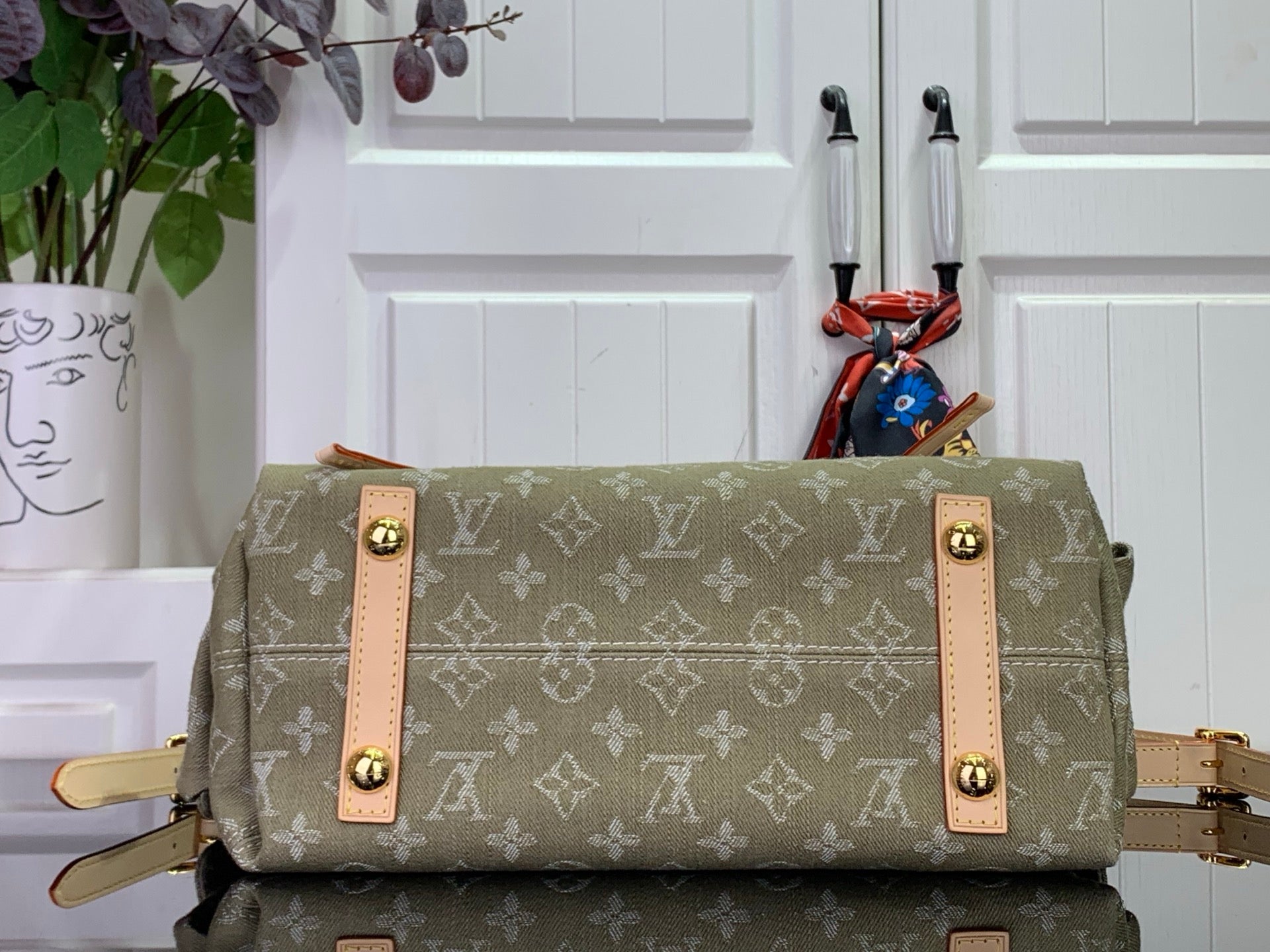 Olive monogram hobo bag with two front flap pockets and tan leather straps