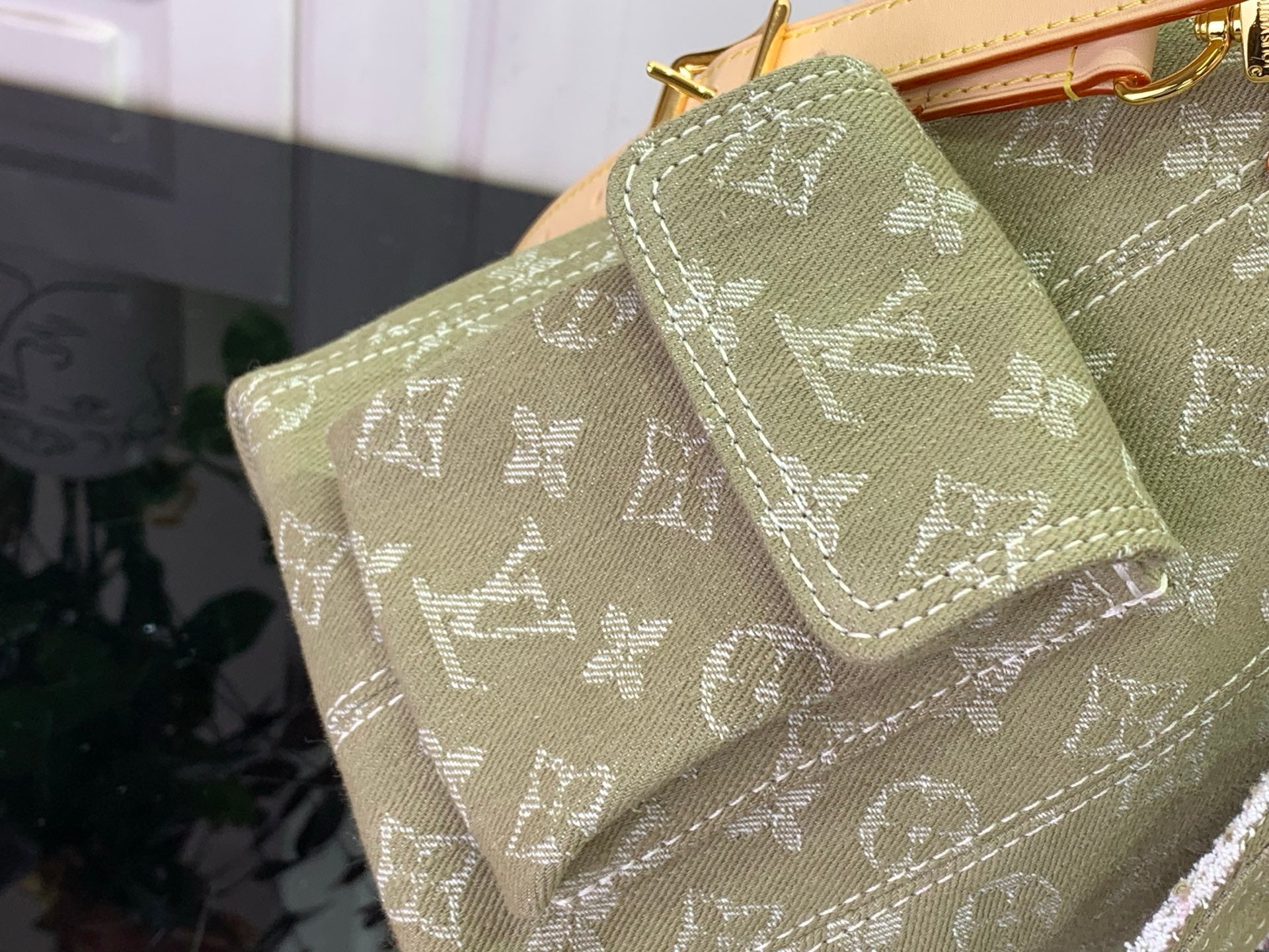 Olive monogram bag corner with stitched edge and layered tan strap