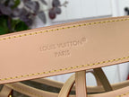 Tan leather strap with embossed LOUIS VUITTON PARIS lettering and stitching