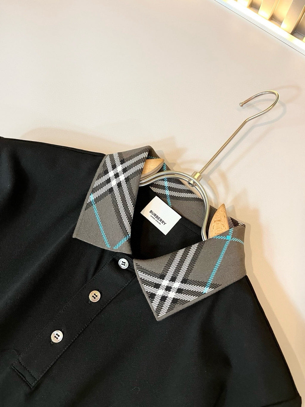 Burberry polo shirt close-up of dark collar and button placket with check print