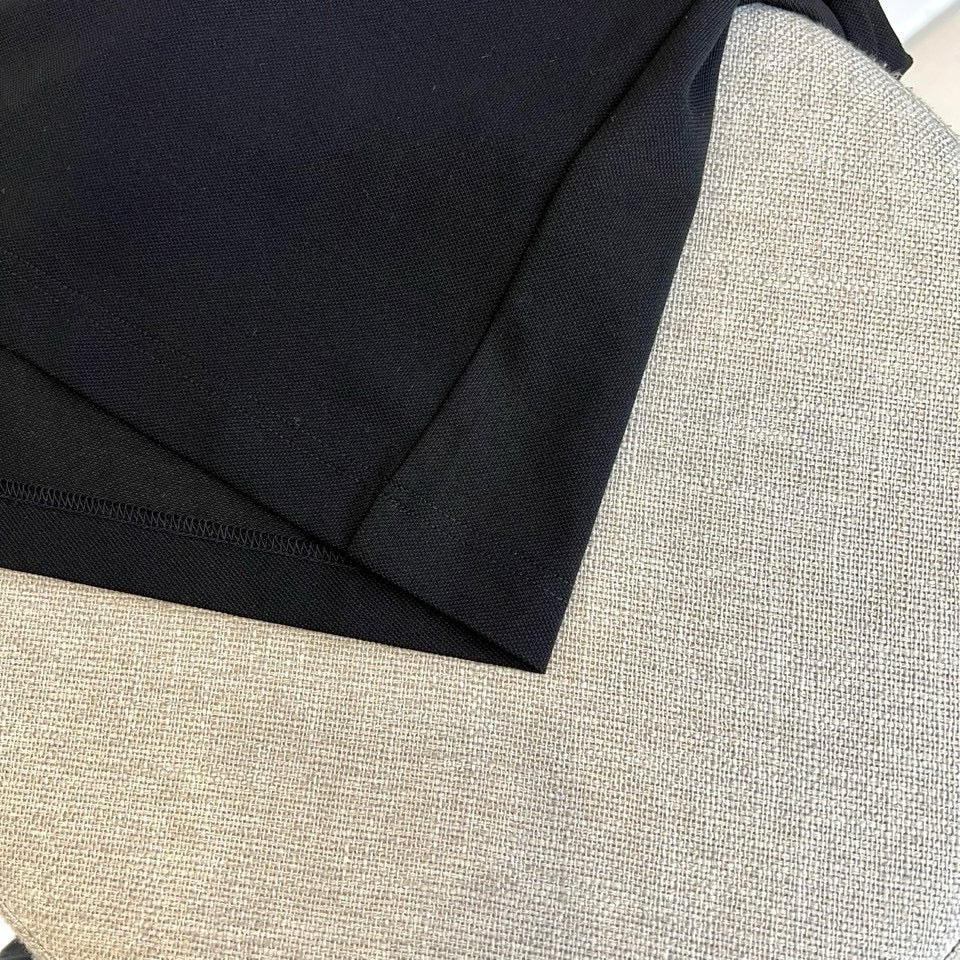 Burberry polo shirt close-up of dark fabric texture and stitched trim