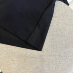 Black polo shirt sleeve hem and stitching detail