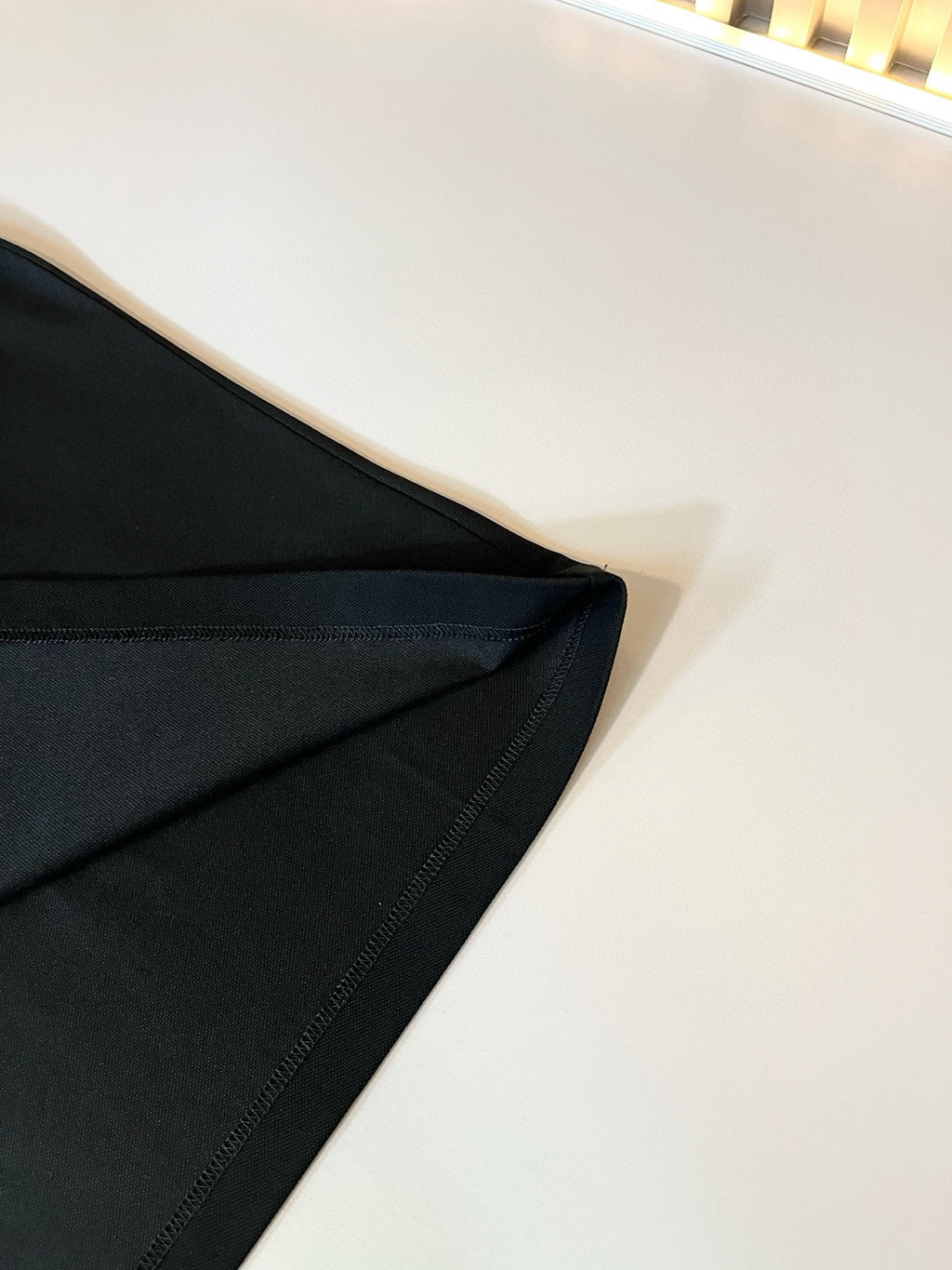 Burberry polo shirt sleeve and side seam close-up in dark fabric