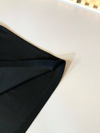 Burberry polo shirt sleeve and side seam close-up in dark fabric
