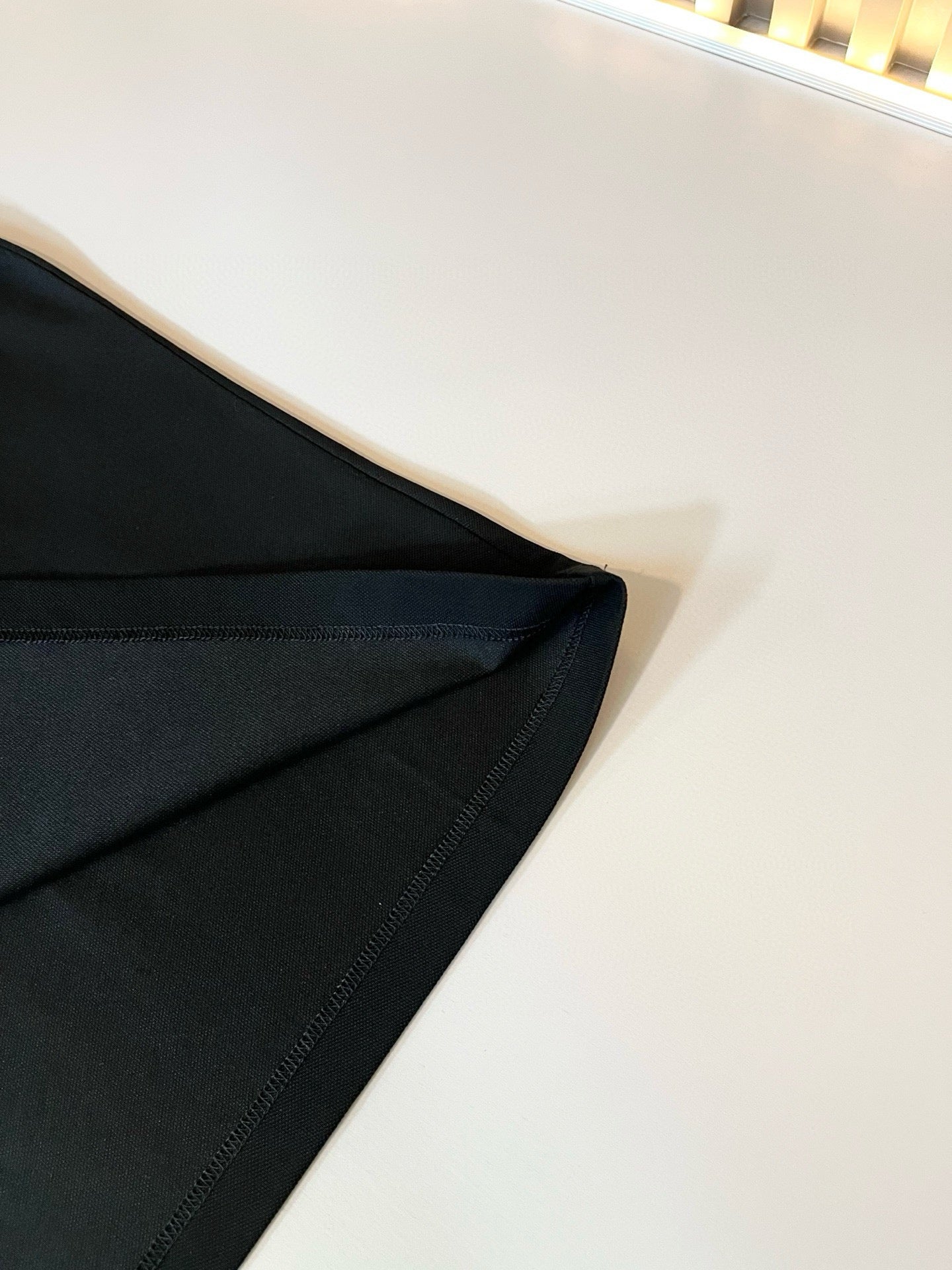 Burberry polo shirt sleeve and side seam close-up in dark fabric