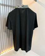 Black polo shirt with plaid contrast collar and short sleeves