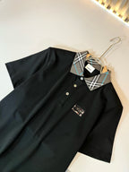 Burberry polo shirt with dark fabric, check-pattern collar, and short sleeves on hanger